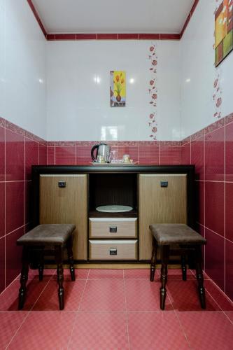 a kitchen with two stools and a sink at Poznyakoff Aparthotel in Kyiv