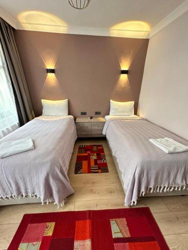 two beds sitting next to each other in a room at Terrace Guesthouse in Istanbul