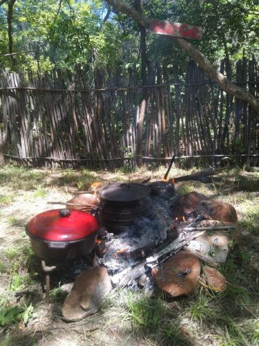 two pots and pans sitting on top of a fire at umbabala bush camp in Rustenburg
