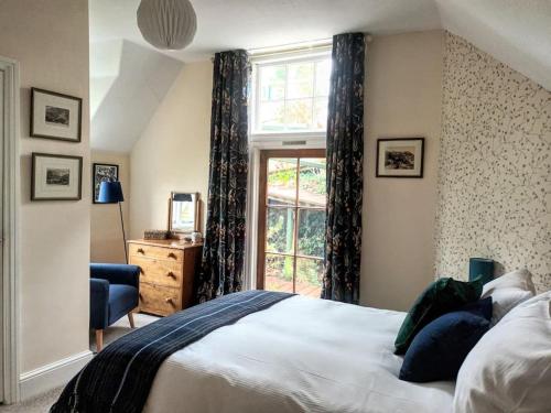 a bedroom with a bed and a window at Bird's Eye View apartment at Countisbury Lodge in Lynmouth