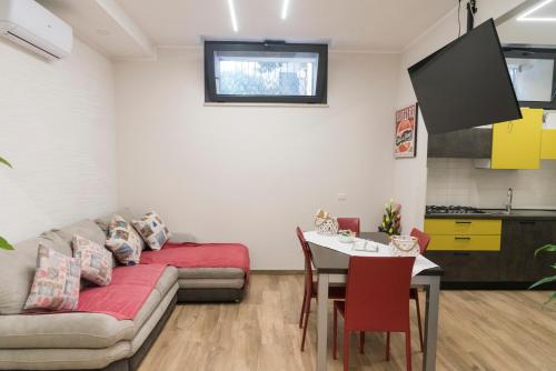 a living room with a couch and a table at Al centro, a due passi dal mare appartamento nuovo in Anzio