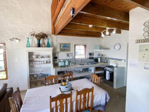 a kitchen with a table and chairs in a room at Shalom in Paternoster