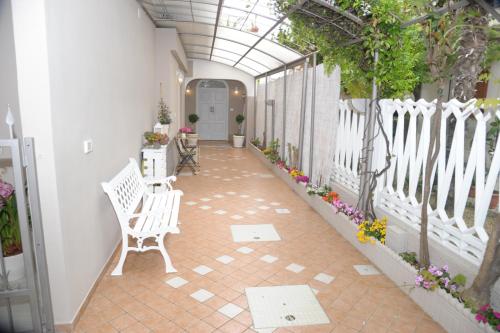 a porch with a white fence and a chair at Mediterranea Sea House in Montesilvano