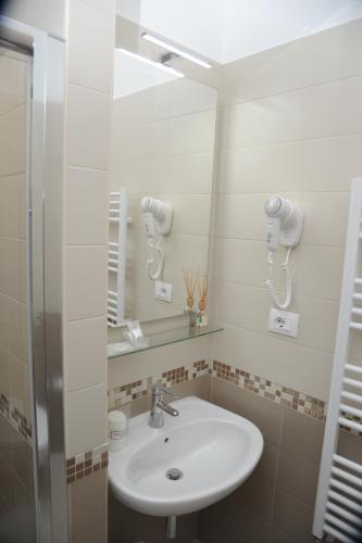 a bathroom with a sink and a mirror at Mediterranea Sea House in Montesilvano