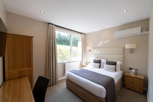 a hotel room with a bed and a window at The Devon Hotel in Exeter