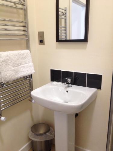 a bathroom with a white sink and a mirror at The New Brighton Hotel in New Brighton