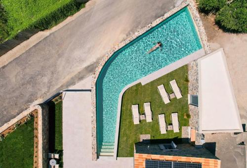 an overhead view of a swimming pool with a person in it at Evge Experience Boutique Hotel in Kafoúros
