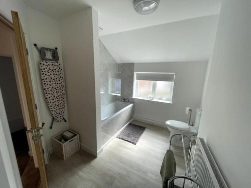 a bathroom with a sink and a bath tub at Cosy apartment in Eccleshall in Eccleshall