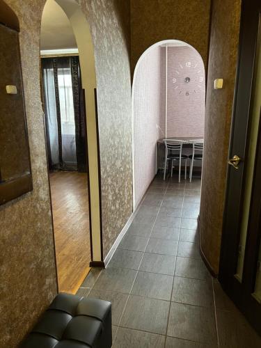 a hallway with a table and chairs in a room at Апартаменты в самом Центре прПобеды 90 in Chernihiv