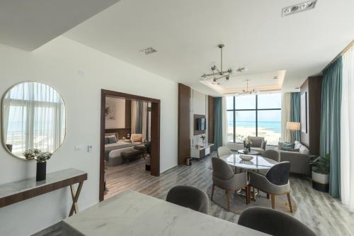 a living room with a dining table and a living room at Tolip Resort Paradise New- Alamein in Marsa Matruh