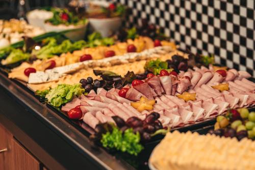 a buffet of different types of food on display at ibis Styles Wałbrzych in Wałbrzych