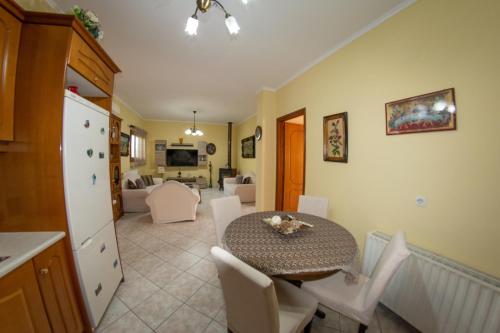 a kitchen and dining room with a table and chairs at Kapetanios Apartments in Agios Stefanos