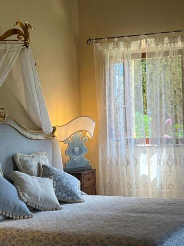 a bedroom with a bed and a window at Il Falconiere Relais & Spa in Cortona