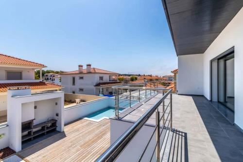 a balcony with a view of a house at Villa Nazaré - Pool, BBQ and Boule/Petanque in Nazaré