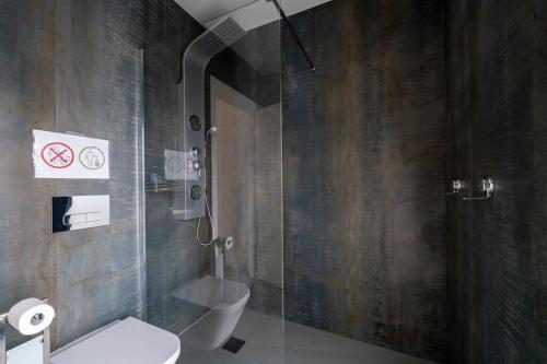 a bathroom with a glass shower and a toilet at Villa Nazaré - Pool, BBQ and Boule/Petanque in Nazaré