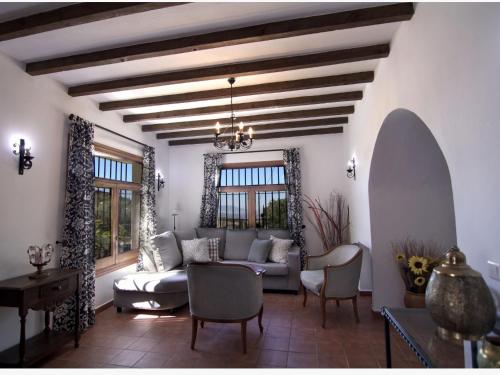 a living room with a couch and chairs at Belvilla by OYO Casa Almendro in La Joya