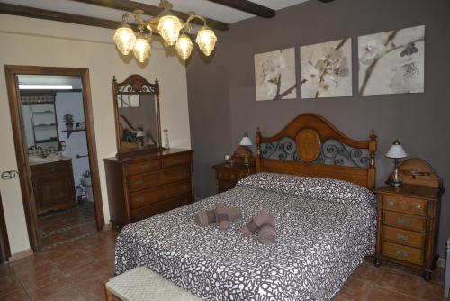 a bedroom with a bed with shoes on it at LA CASA DE GALAPAGAR ALOJAMIENTO SIETE PICOS in Galapagar