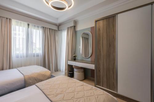a hotel room with two beds and a mirror at Gewan White Beach Resort-New Alamein in Marsa Matruh