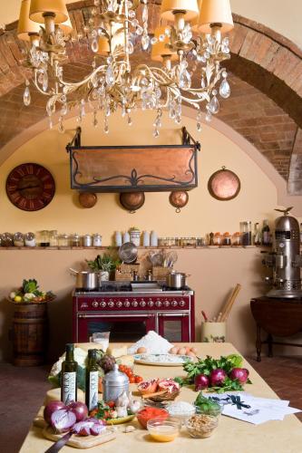 a kitchen with a table with food on it at Il Falconiere Relais & Spa in Cortona
