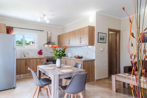 a kitchen and dining room with a table and chairs at Villa Georgia in Lefkímmi