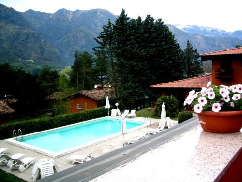 a swimming pool in front of a house with mountains at Villa (home D) — Pool — Lake Idro in Vesta