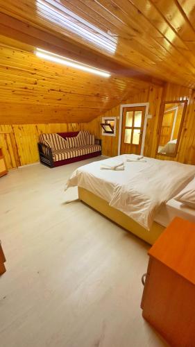 a bedroom with a bed and a couch in a room at ZEREN APART 2 CENTRUM in Uzungöl
