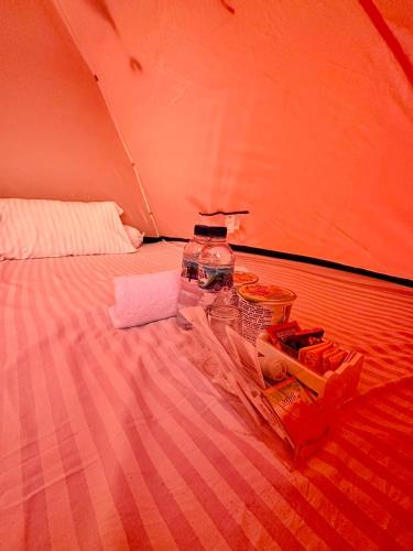 a group of water bottles sitting on a bed at Glamping Omah Kayu at Watu Paris Jogja in Girijati