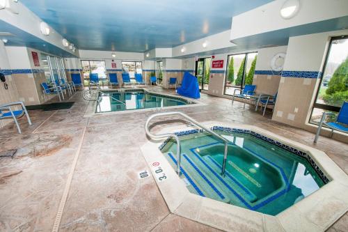 TownePlace Suites by Marriott Scranton Wilkes-Barre في Moosic: غرفة بحمام سباحة مع مسبحين وحوض استحمام ساخن