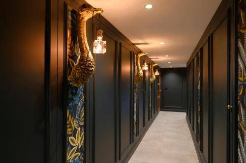 a hallway with black walls and a chandelier at Secret Jacuzzi Mons - Parking privé gratuit in Mons