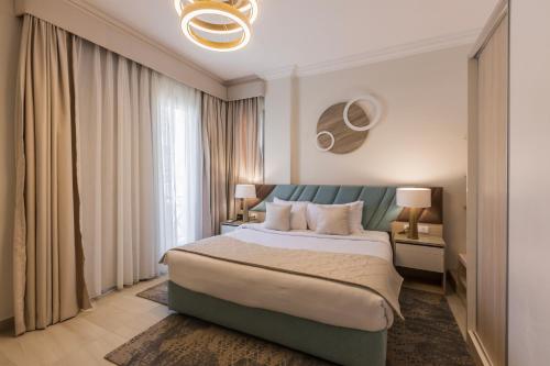a bedroom with a bed and a large window at Gewan White Beach Resort-New Alamein in Marsa Matruh