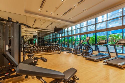 a gym with a lot of treadmills and ellipticals at FAM Living - RP Heights - 3 Mins Walk to Burj Khalifa & Dubai Mall Downtown Dubai in Dubai