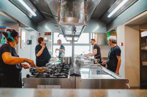 a group of people in a kitchen preparing food at Millennium Hub & Hotel in Constanţa