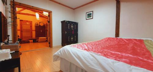 a bedroom with a bed and a dresser in a room at Hanok Moryeon in Jeonju