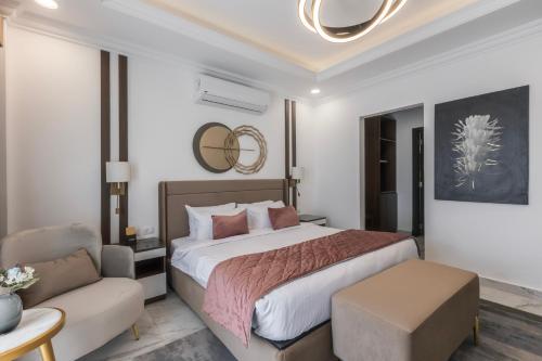 a bedroom with a large bed and a couch at Gewan White Beach Resort-New Alamein in Marsa Matruh
