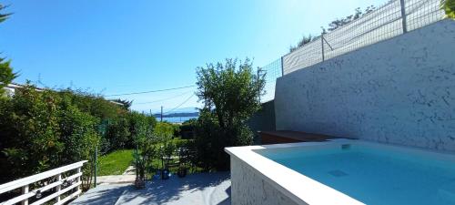 a swimming pool on the side of a building at Wooden Summer House in Mantoúkion