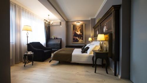 a hotel room with a bed and a chair at Cincis by the Lake in Cinciş
