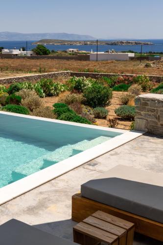 a swimming pool with a view of the ocean at Cycladic Breeze Villas in Kampos Paros