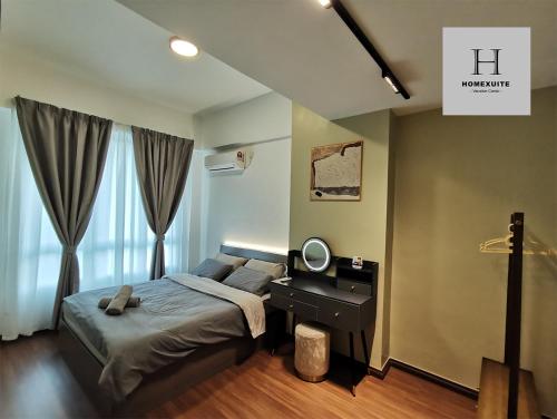 a bedroom with a bed and a desk with a mirror at Homexuite Vacation @ Sri Indah in Sandakan