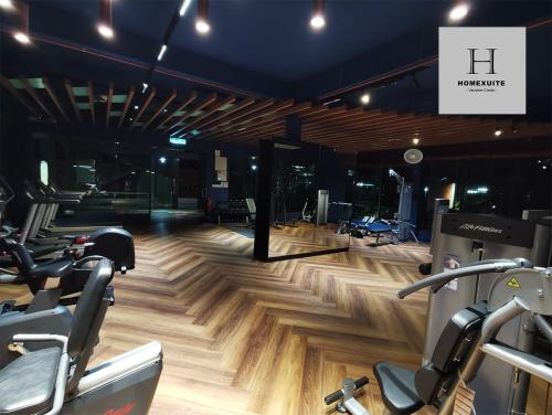 a gym with treadmills and exercise bikes in a room at Homexuite Vacation @ Sri Indah in Sandakan