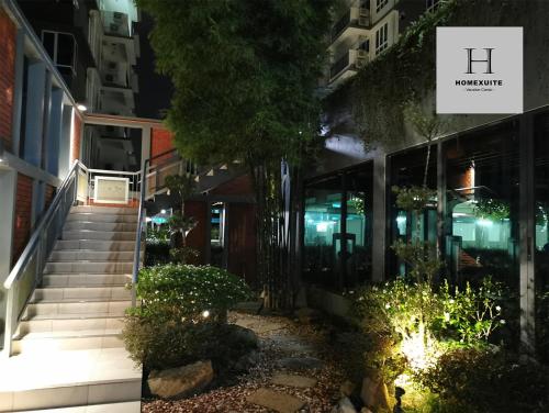 a set of stairs leading to a building at night at Homexuite Vacation @ Sri Indah in Sandakan