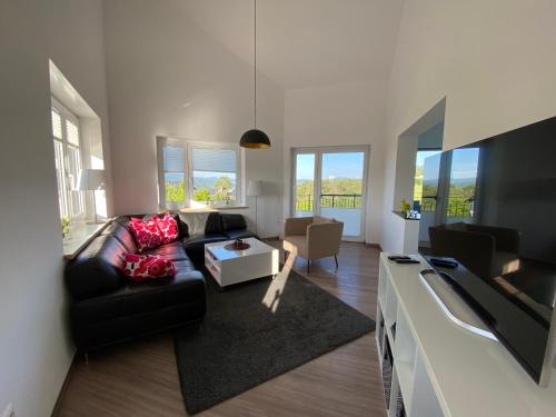 a living room with a couch and a tv at Ferienhaus Eckeweg 1 in Waldeck