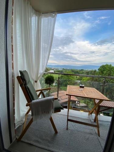 a chair and a table on a balcony with a view at Rezidencia pod Zámkom Bojnice Apartmán Luna in Bojnice