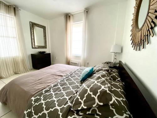 a bedroom with a bed with a giraffe blanket at Steps to the beach! in Miami Beach