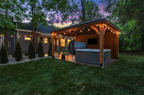 a barbecue under a gazebo in a yard at The Luxe/Hot Tub/12min to Horse Park/30 Min to Ark in Georgetown