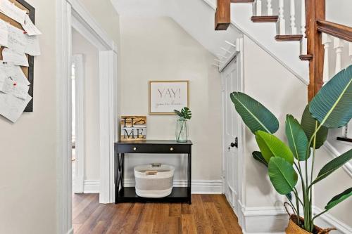 a hallway with a stairway with a black table at The Luxe/Hot Tub/12min to Horse Park/30 Min to Ark in Georgetown