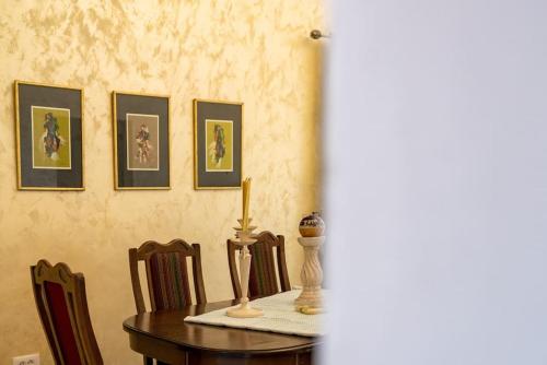 a dining room table with a candle and chairs at Pool & River House - Lazara in Danilovgrad