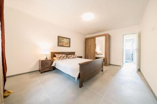 a bedroom with a bed and a dresser and a mirror at Pool & River House - Lazara in Danilovgrad