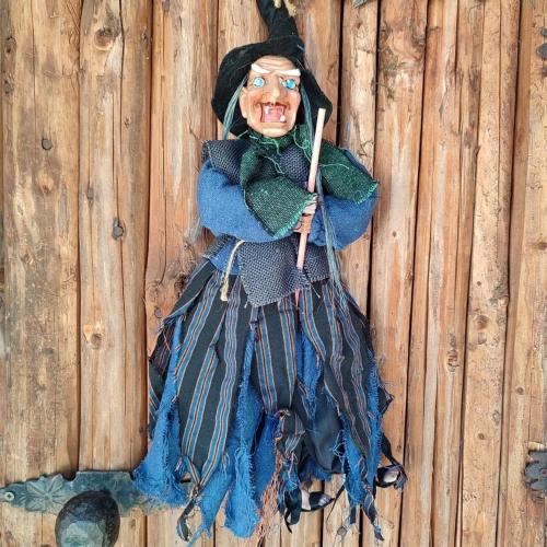 a wooden scarecrow hanging on a wooden wall at Mała Bawaria in Zakopane