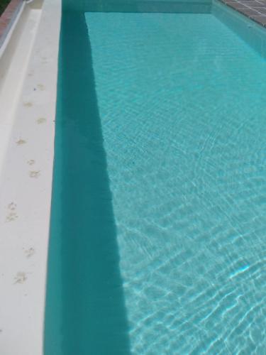 a blue swimming pool with a reflection in the water at Villa Belvedere in Pieve Fosciana