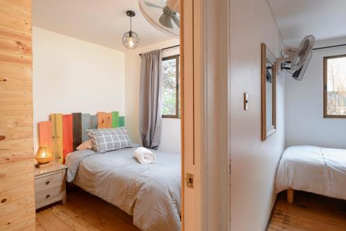 a bedroom with two beds and a window at Verde Madera Hostel B&B in Santiago
